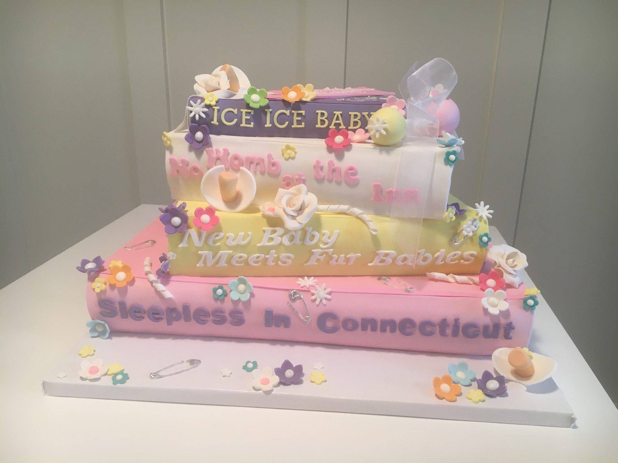 Baby shower cake styled as a stack of storybooks